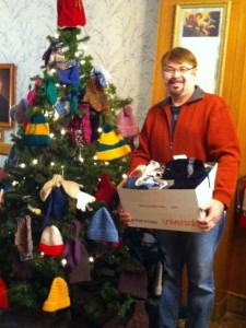 Reverend Phillip Schneider of Saint Paul’s United Church of Christ; the congregation donated hand-knit hats, mittens, scarves & booties